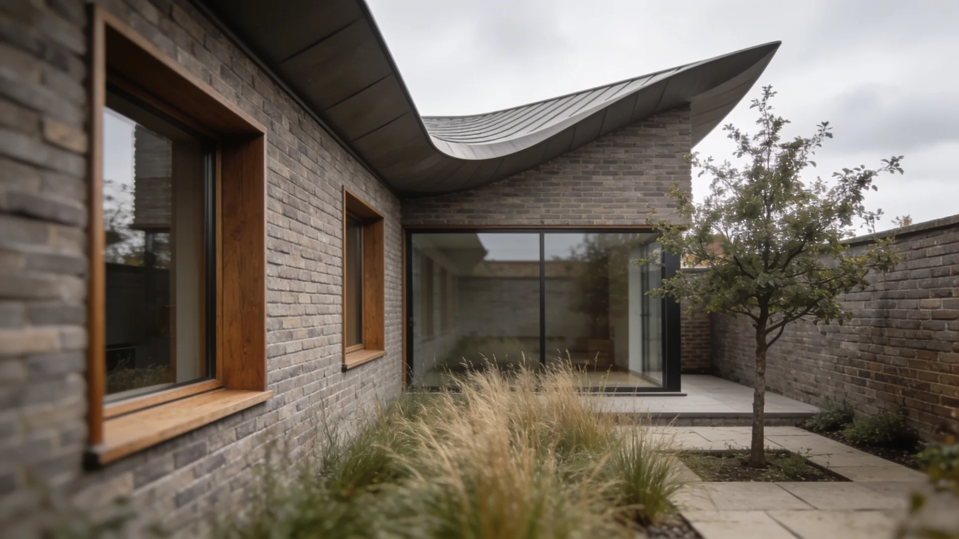 A contemporary brick home wrapped around a planted courtyard